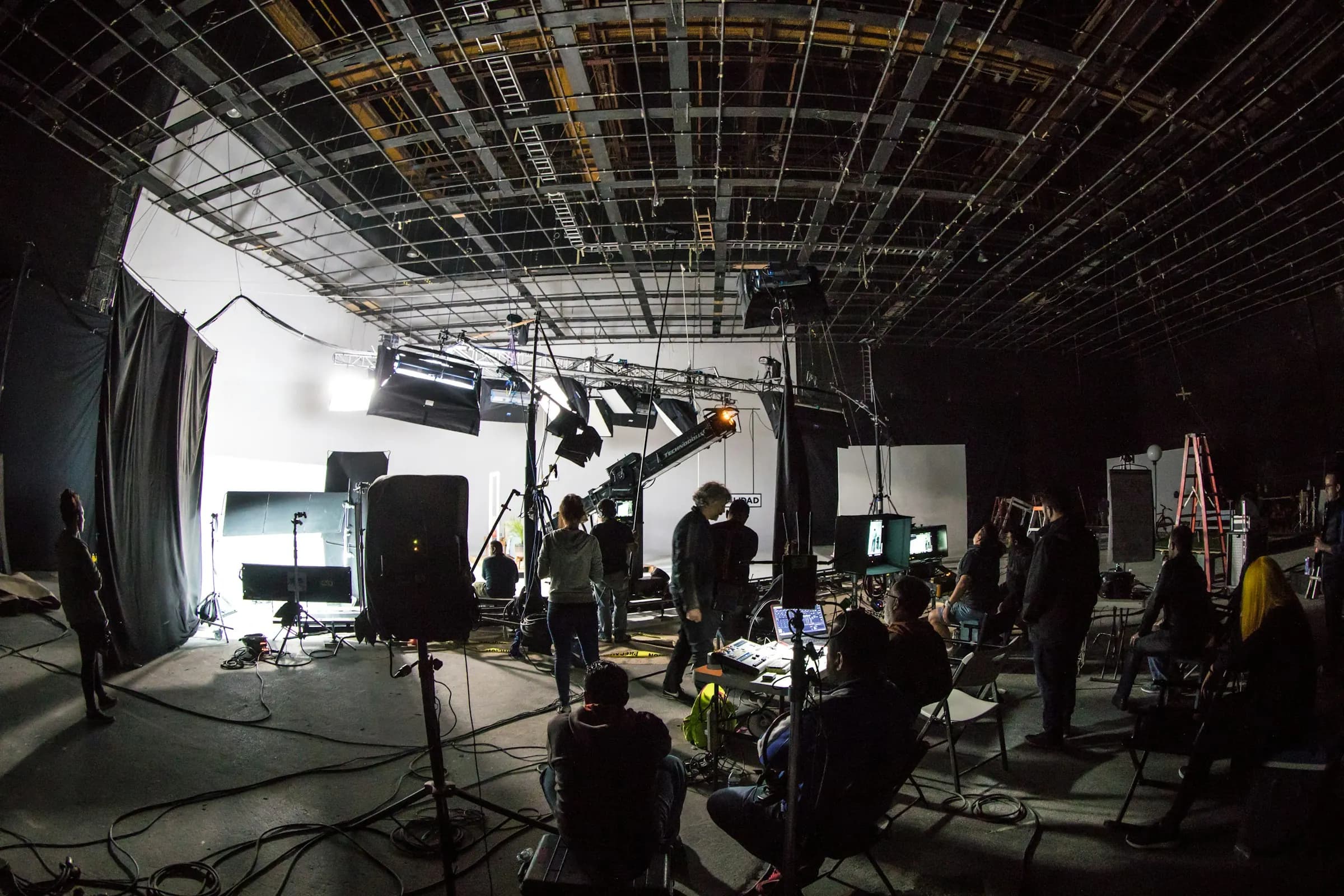 A film crew working on a lit soundstage